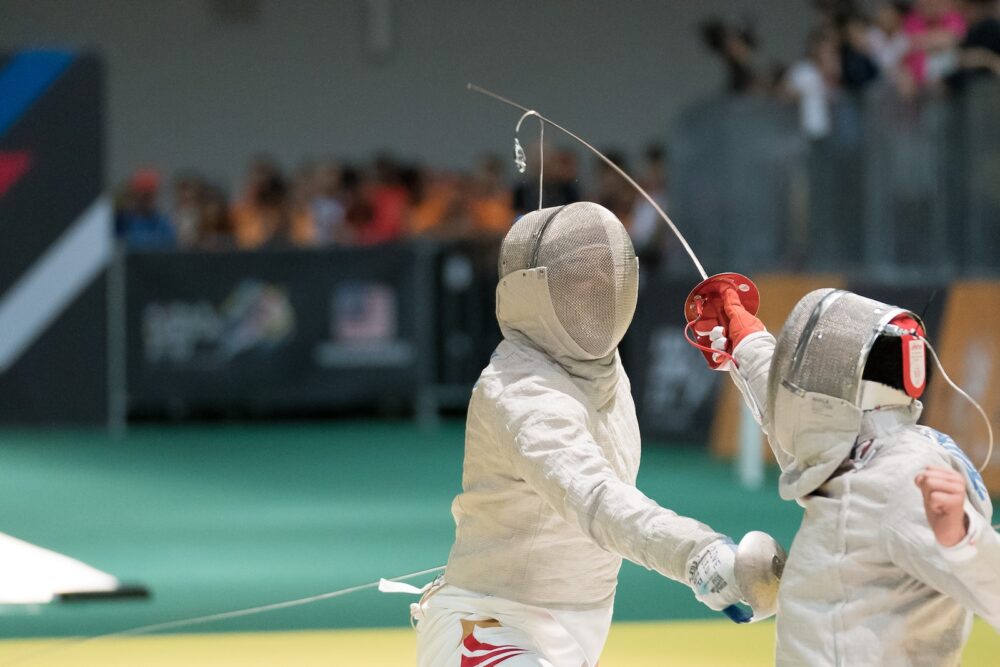 two person fencing inside the gym